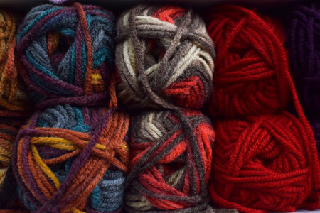 Shop shelves with multicolored skeins of yarn for knitting. Yarn for knitting for needlework. Bright multicolored threads.の写真素材