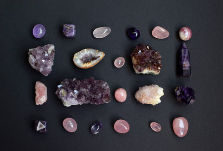 Background of beautiful natural colored semi-precious stones. Purple fluorite, rose quartz and...