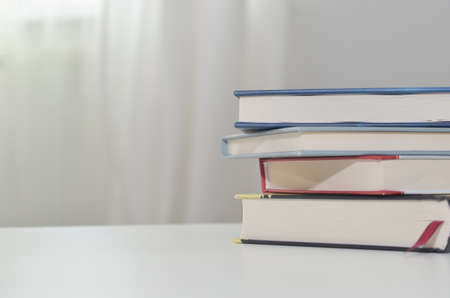 Stack of books on the white tableの写真素材