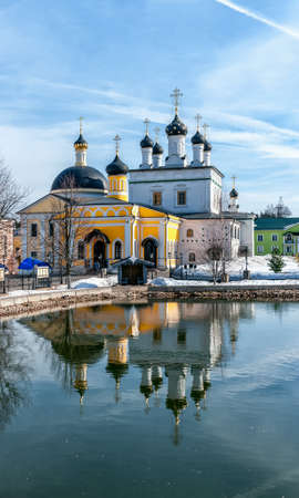vintage Voznesenskaya Davidova Pustyn monastery Chekhov district, Russia, historical and cultural monuments of the vertical frame with reflection in waterの写真素材