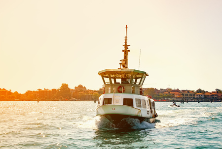 Yacht at seYacht at sea against the backdrop of Venice at dawn. Sunny. The horizontal frame.の写真素材