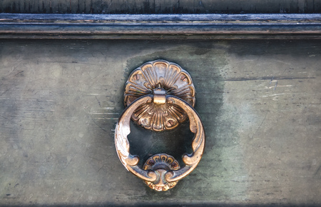 Antique dark wooden door with round metal knob, background. The horizontal frame.の写真素材