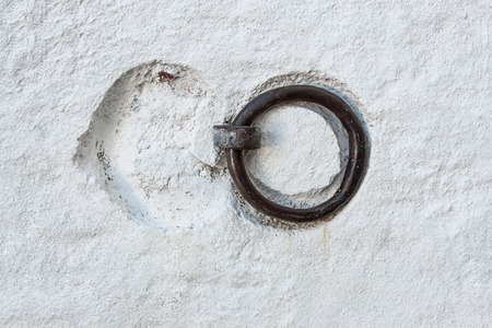 Metal ring with recesses of the old texture white concrete wall. Background.の写真素材