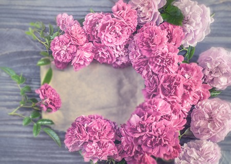Beautiful background of red and pink flowers roses on wooden background. Tinted glass. Copy space. The horizontal frame.の写真素材