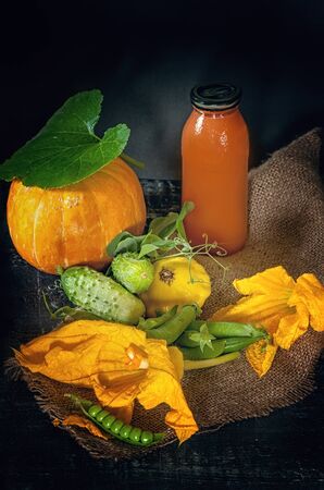 Vegetables - pumpkins, cucumbers, zucchini and green peas in a rustic style on wooden background. Art. The horizontal frame.の写真素材