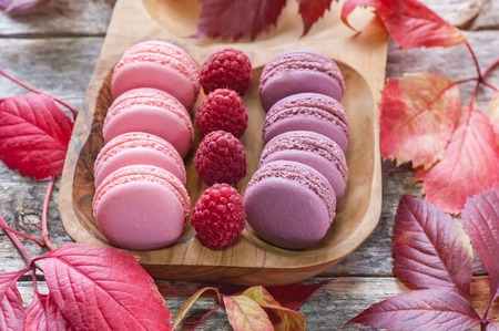 Pink and white Macaroni with raspberries and a beautiful rose flower. Dessert close-up. The horizontal frame.の写真素材