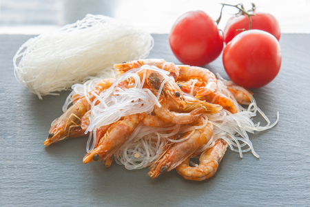 Rice noodles - cellophane boiled shrimp on the grill, spices and tomatoes. The Asian kitchen.の写真素材