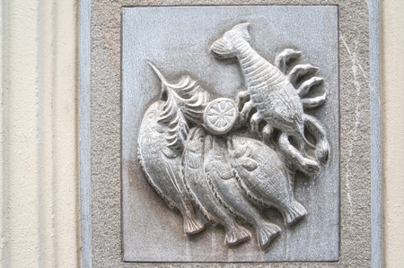White bas-relief figure of a fish and a lobster.の写真素材