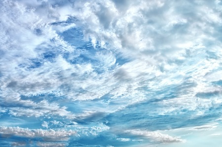 Beautiful light clouds at sunset over the coastline of the Mediterranean sea. The horizontal frame.