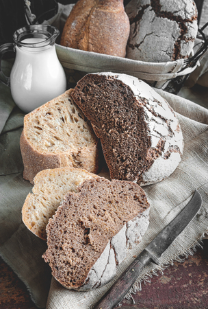 A beautiful loaf of rye farm sourdough bread is handmade. Close-up. The vertical frame.