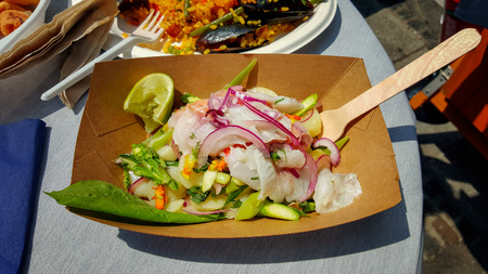 Low-calorie salad of mozzarella, vegetables, onion seafood and lime on the table in the cafe. Low-calorie diet. Healthy food.の写真素材