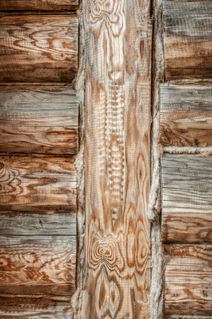 textured wooden beams insulated with a tow in the old house vertical frameの写真素材