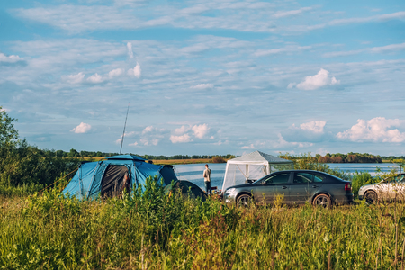 The tourist camp of tents on a river in summer Sunny weather. The horizontal frame.の写真素材