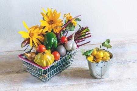 Basket from supermarket with different vegetables pepper eggplant zucchini and tomatoes. The harvest from the farmers garden.の写真素材