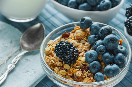 Healthy Breakfast cereals: muesli with fruits and berries blueberries, blackberries and dairy products. Selective focus. Close up. The horizontal frame.の写真素材
