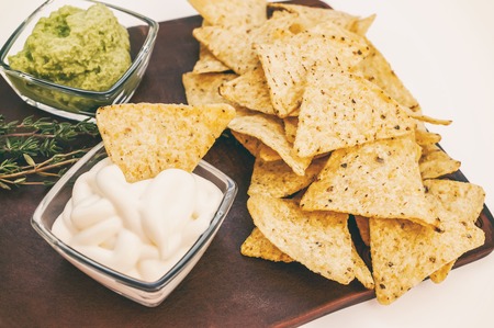 Background of corn tortillas or Nachos fried over an open fire with caeso sauce and Salsa. Copy space.の写真素材