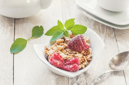 Healthy cereal cereal with fruits and strawberries and raspberries with dairy products and mint . Selective focus.The concept of higher nutrition.の写真素材