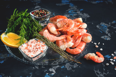 Frozen cooked shrimp to cooking with lemon dill and spices. Close up. Selective focus.の写真素材