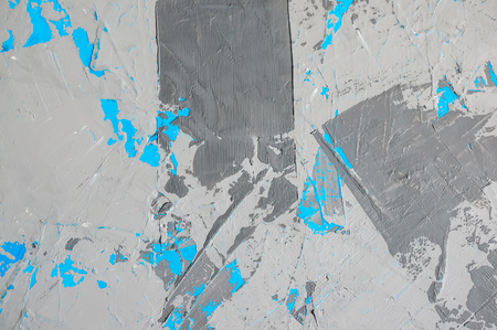 Background of natural cement plaster on the wall grey with a blue fragments are textured with cracks.の写真素材