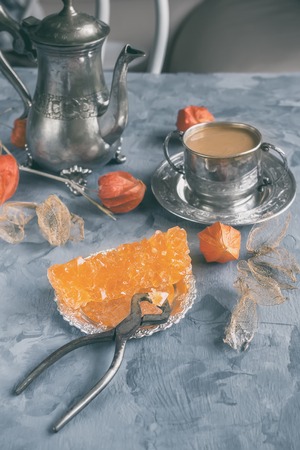 Brown Grape sugar in clear crystals, tea and tongs on grey slate close-up. Oriental sweetness to tea.の写真素材