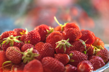 Ripe juicy red strawberries, on a blurred background. Close up. Selective focusの写真素材