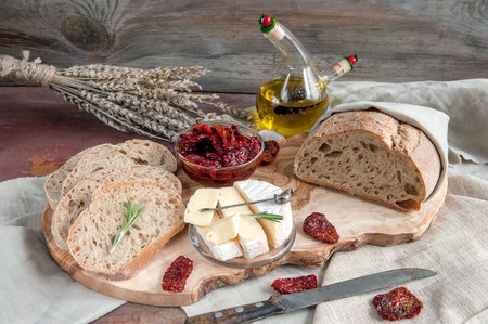Bread whole wheat processed cheese Camembert with sun-dried tomatoes with rosemary and olive oil....