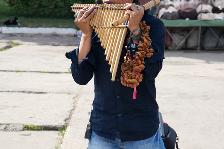 A street performer from Peru performing Latin American music on traditional instruments on the...