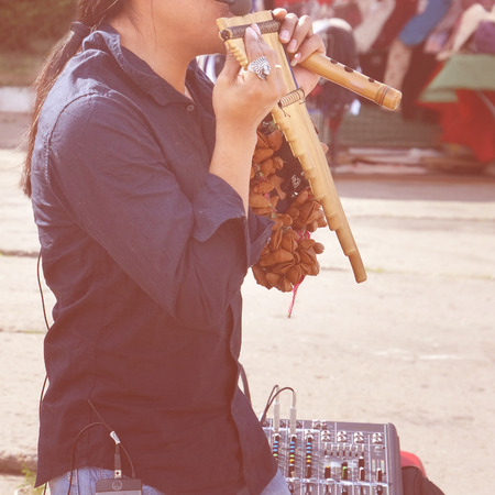 A street performer from Peru performing Latin American music on traditional instruments on the street.の写真素材