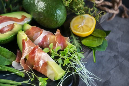 Delicious toasts of avocado and prosciutto with green sprouted mustardの写真素材