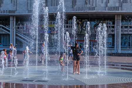 Russia, Yaroslavl August 04 2018 . Children swim in the street in the fountain in hot weather. Extreme heatのeditorial素材