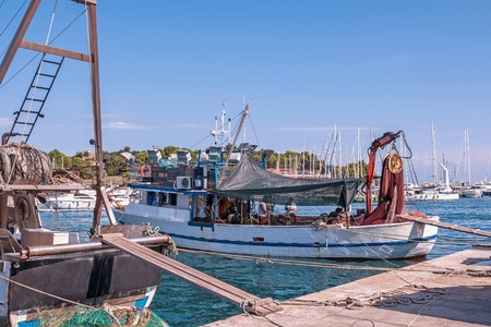 an old fishing boat is prepared to go out to sea for fishing. the quota for catching fish. small businessの写真素材