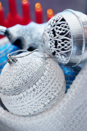 Christmas decorations. Beautiful white and blue balls with a red candlestick.の写真素材