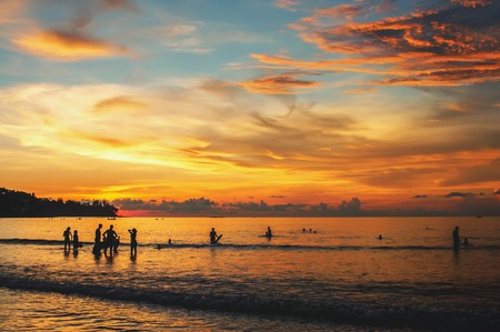 Beautiful scenery of the ocean at sunset with a wave on the shore and bizarre clouds .の写真素材