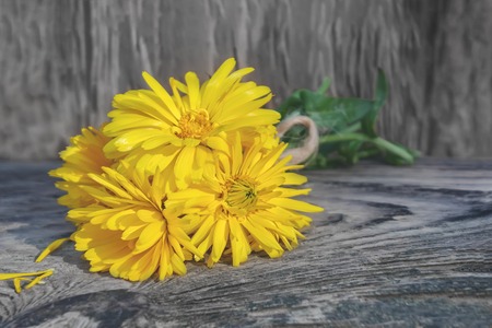 A bouquet of marigold flowers on an old woodenの写真素材