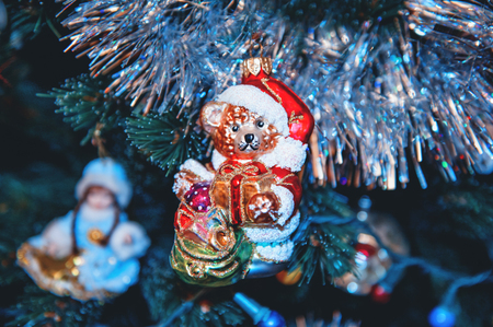 Beautiful Christmas decorations in the shape of a bear, hanging on the Christmas tree. Home Decoration for Christmas.の写真素材