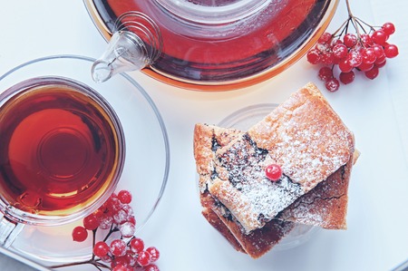Layer cake with poppy seeds with hot berry tea on a winter day. Top view.の写真素材