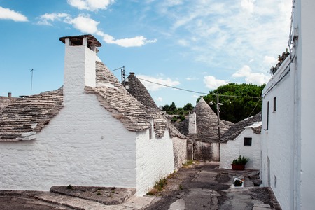Brick houses trulli in Alberobello. Puglia Italy on a sunny day.の写真素材