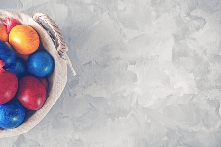 Colorful easter eggs lying in a basket on a beautiful vintageの写真素材