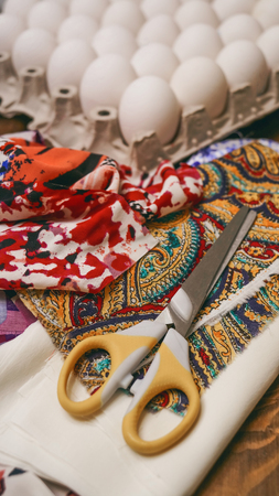 Chicken white eggs ready to decorate with pieces of colored fabric for Easter. Close-up. The vertical frame.の写真素材