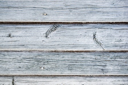 The original wooden background of thin old boards. Texture. Brown textured boards, located...