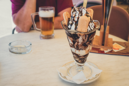 Ice cream. Dessert based on vanilla ice cream and chocolate syrup with cookies. cup with ice cream.の写真素材