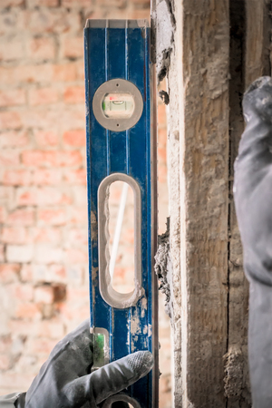 Alignment of walls in the repair with the help of a special device level. Close up.の写真素材