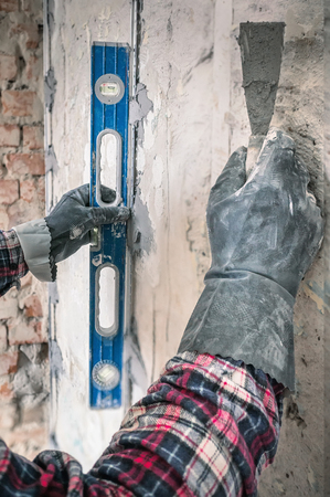 Alignment of walls in the repair with the help of a special device level. Close up.の写真素材