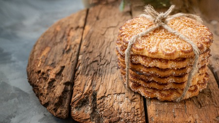 Stack of yellow, sugar homemade cookies on a beautiful wooden background. Copy space.の写真素材