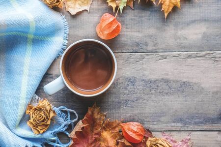 Beautiful autumn composition with tea. autumn leaves and cups with grape sugar on a rustic treeの写真素材