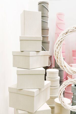 Plain gift boxes of different shapes on the shelves of the Hypermarket . Festive minimal gift...