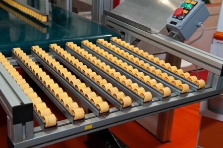 Conveyor for transporting cassettes with seedlings in the farm. Mechanization of hard work of farmers.の写真素材