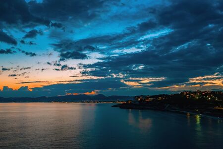 Dramatic sunset over the coastline after a thunderstorm