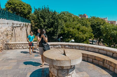 Cambrils Spain August 8, 2013 . Roman amphitheatre of Tarragona, Spain. Tourists take pictures of the sundial. An ancient historical tourist attraction of Catalonia.のeditorial素材