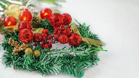 Christmas tree toys red berry balls hanging on Christmas tree on light background with ribbon from Christmas tree. Copy space, background.の写真素材